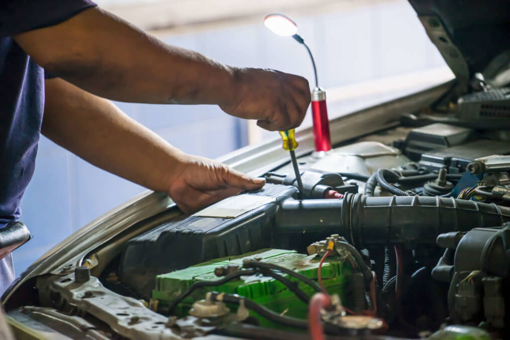 homem mostrando como funciona uma bateria automotiva