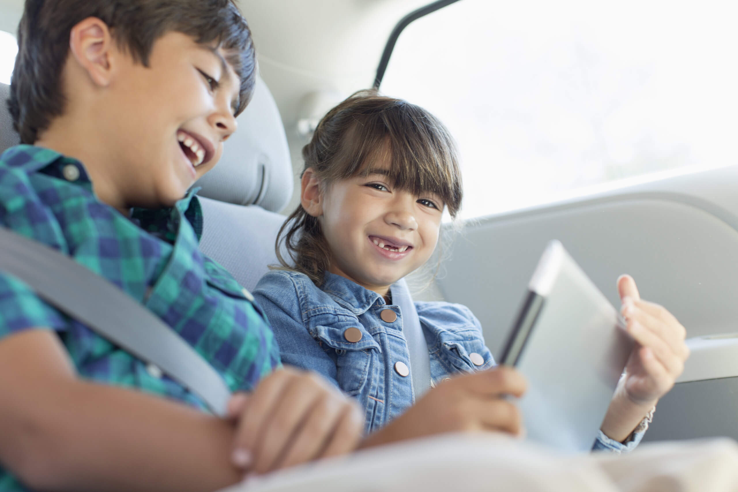Imagem de duas crianças em um dos tipos de carros feito para famílias com filhos